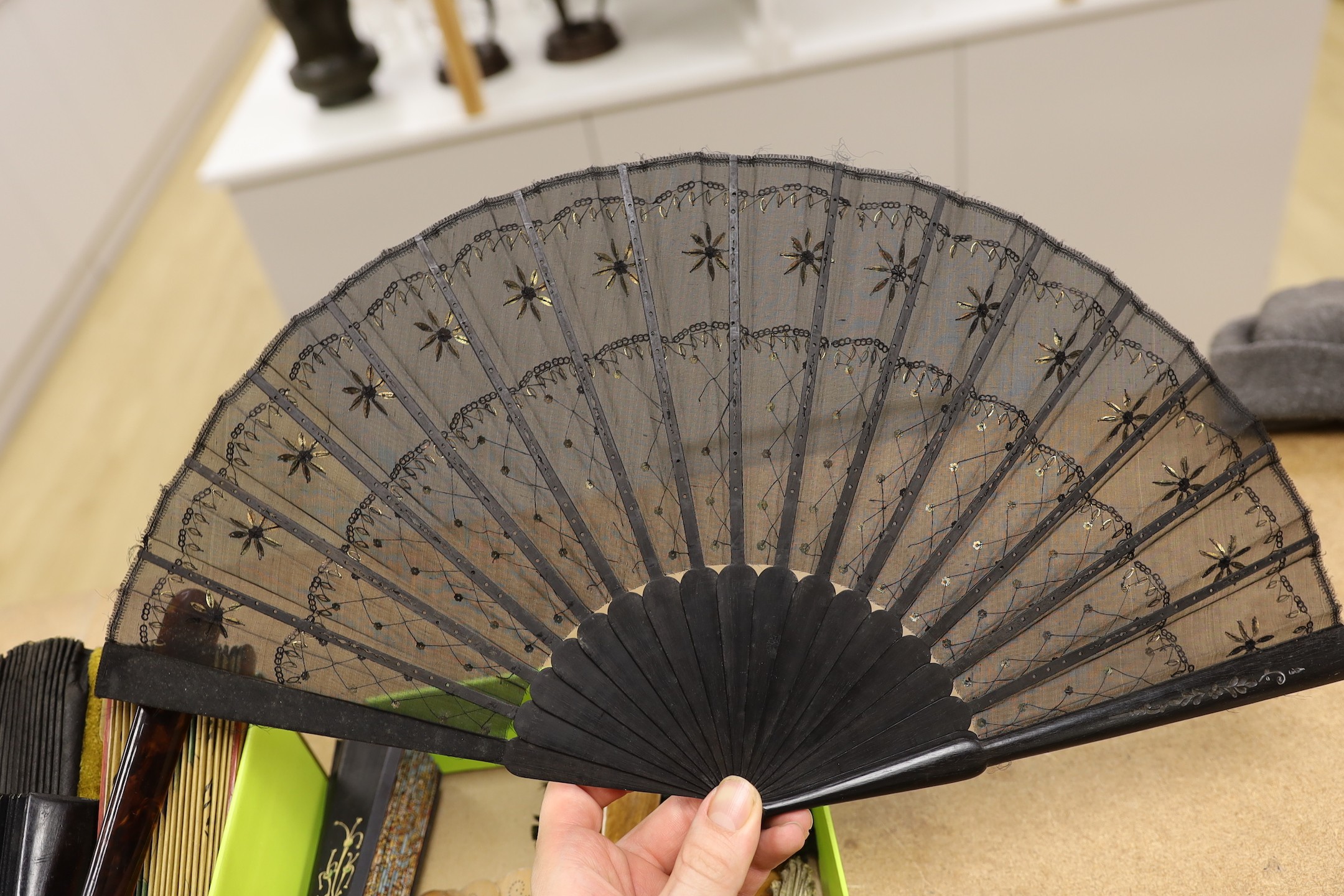 An unusual 19th century feather fan, three sequin and gauze fans, a paisley fan, Sandalwood fan and a collection of later fans and stick guards, feather fan 33cms high